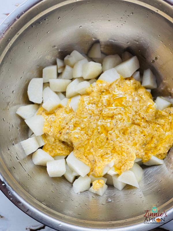 pour-in-the-mixture-into-the-potato-and-mash-with-a-mixer 