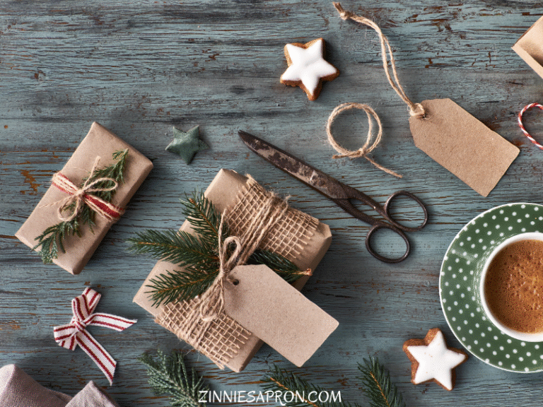 Flat lay showing cozy DIY Christmas crafts on wooden table with festive lighting and materials
