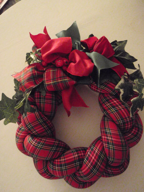  Rustic braided fabric wreath with chunky textiles and cheerful holiday ribbon as one of diy Christmas crafts
