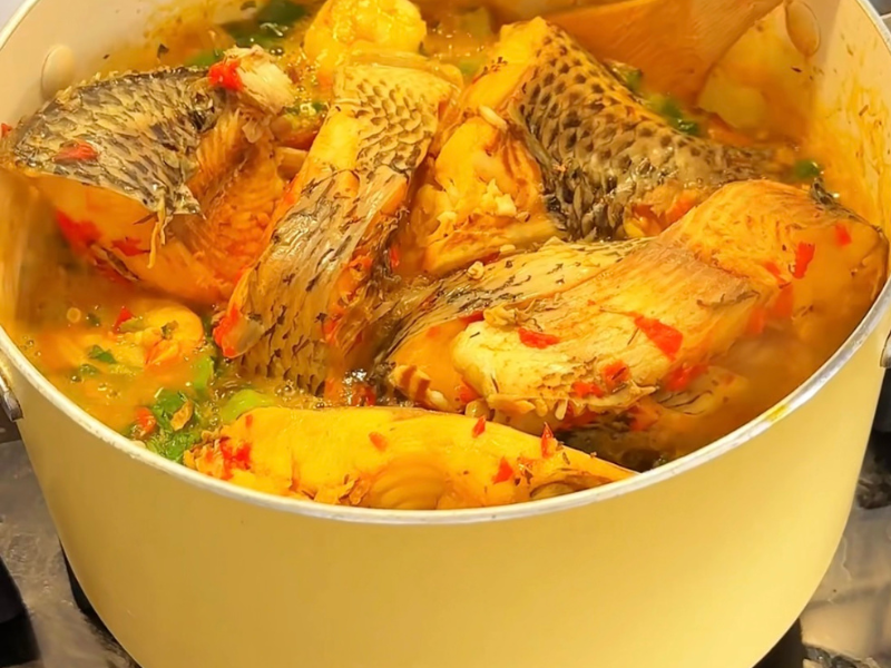 okro soup cooking in a pot with fish
