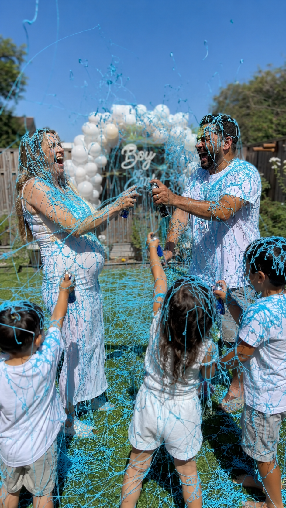 silly-string-gender-reveal-pink-parents-children-backyard