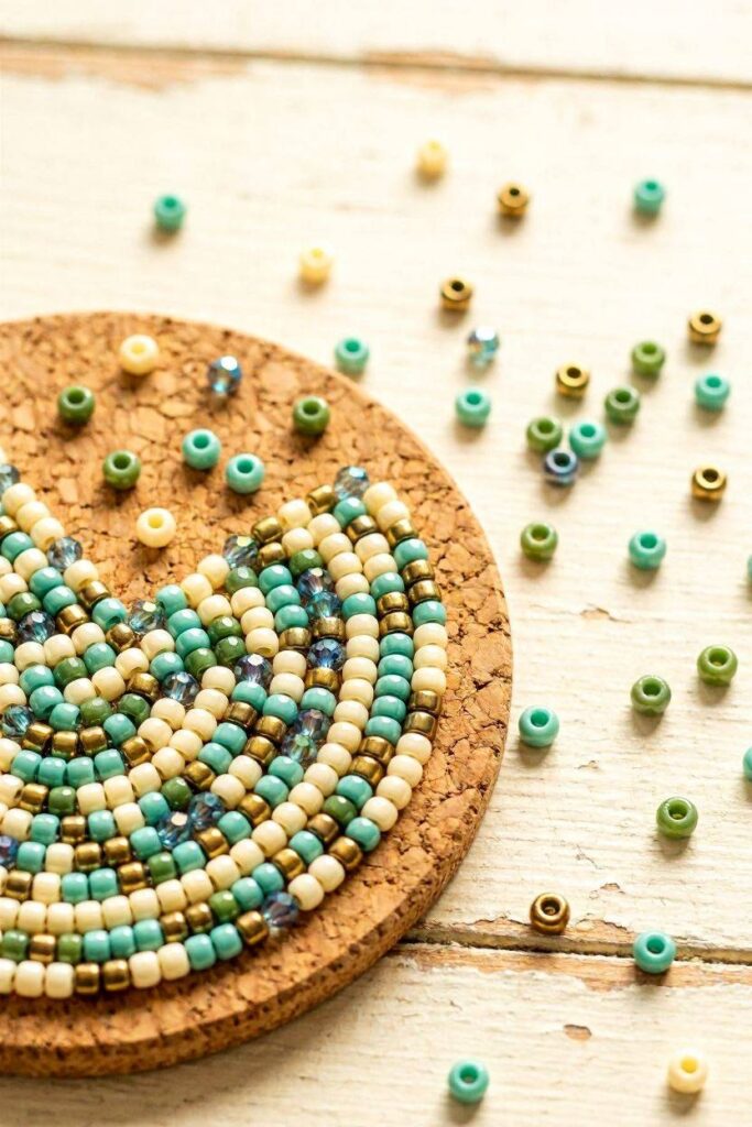 A_cork_coaster_partly_covered_in_a_mosaic_bead_pattern_loose